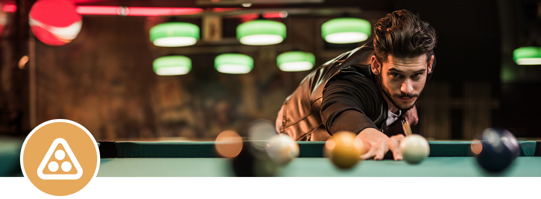 Focused billiards player lining up a shot.