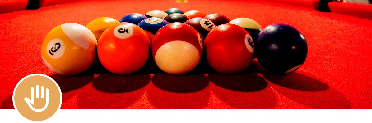 Billiard balls arranged on red table