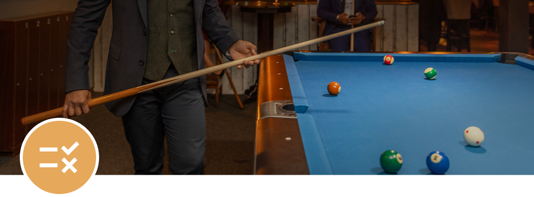 Person holding cue at billiards table