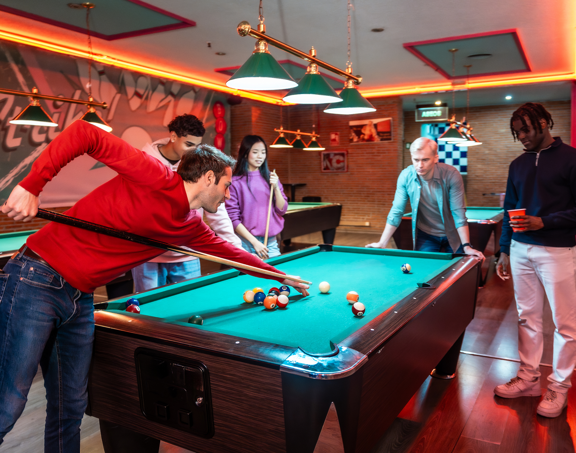 Friends enjoying a game of billiards