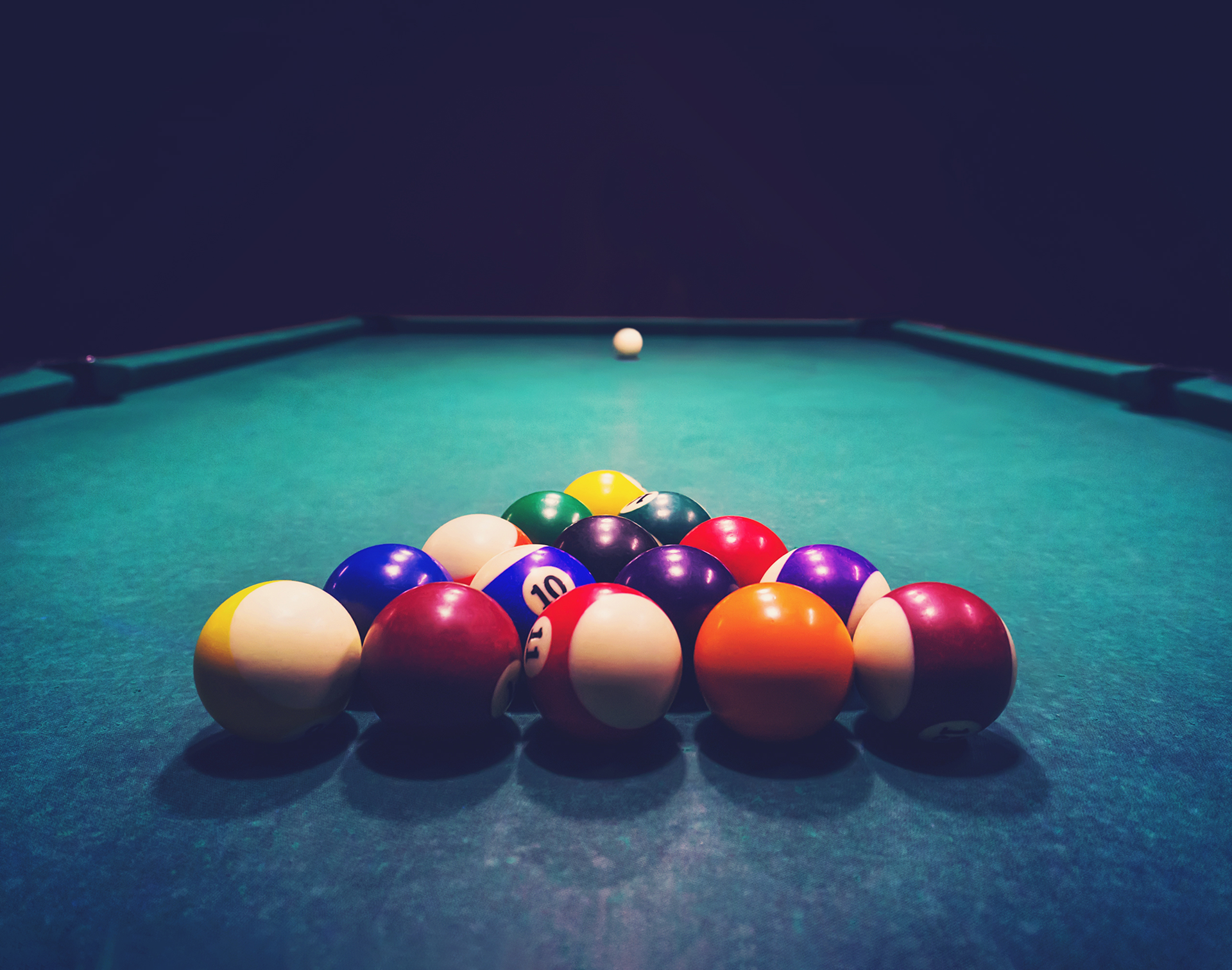 Billiard balls set on pool table