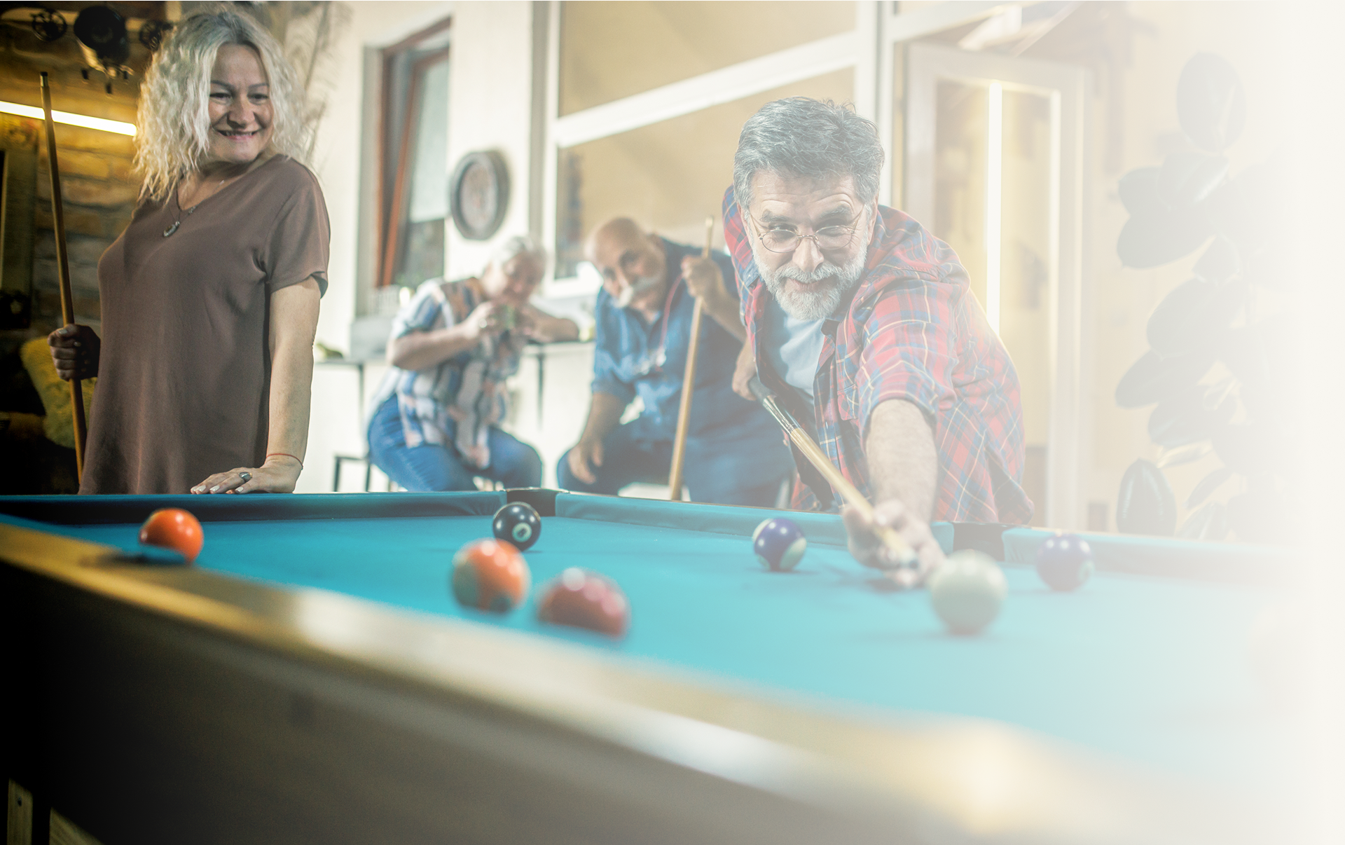 Seniors enjoying a game of billiards