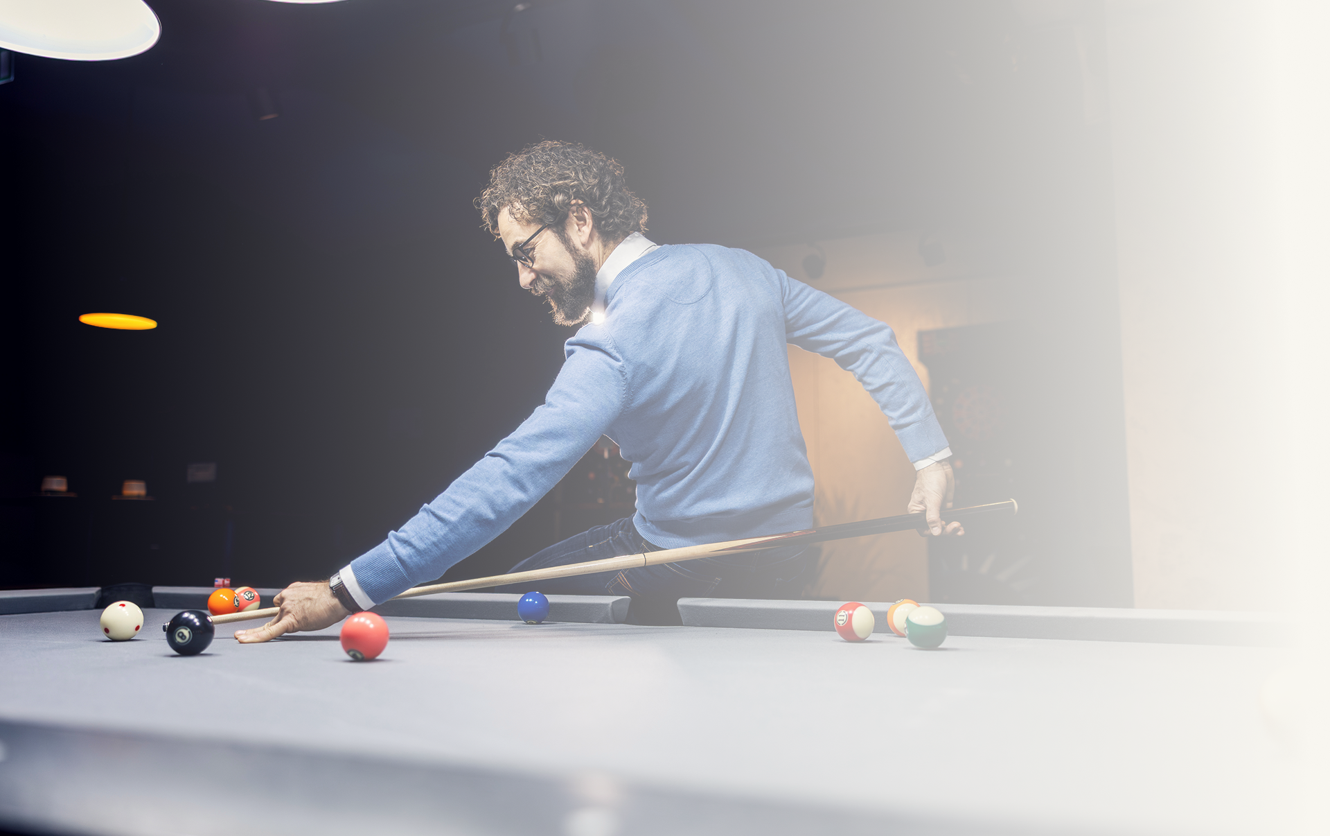 Person taking a shot in pool game