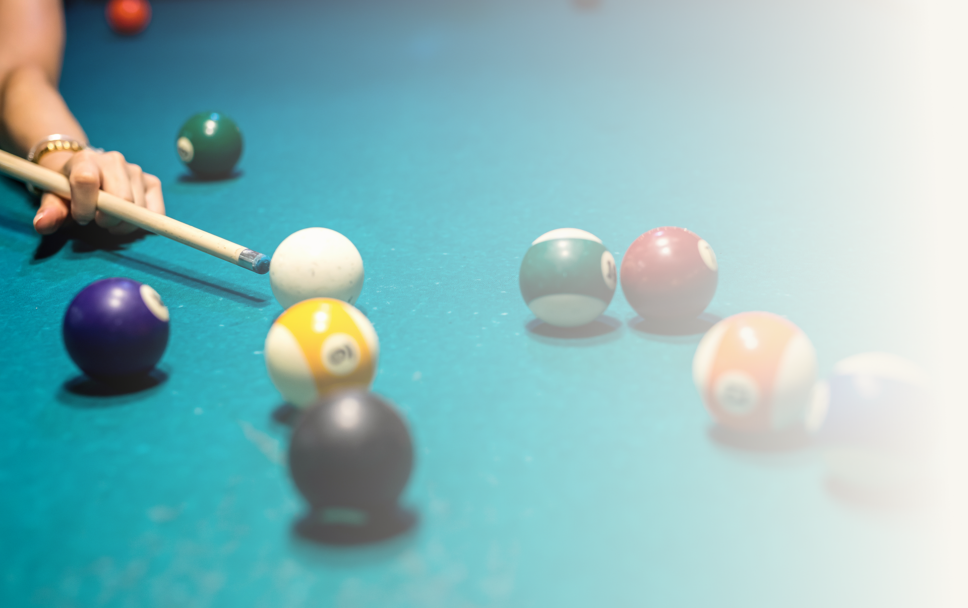Pool table with player aiming shot